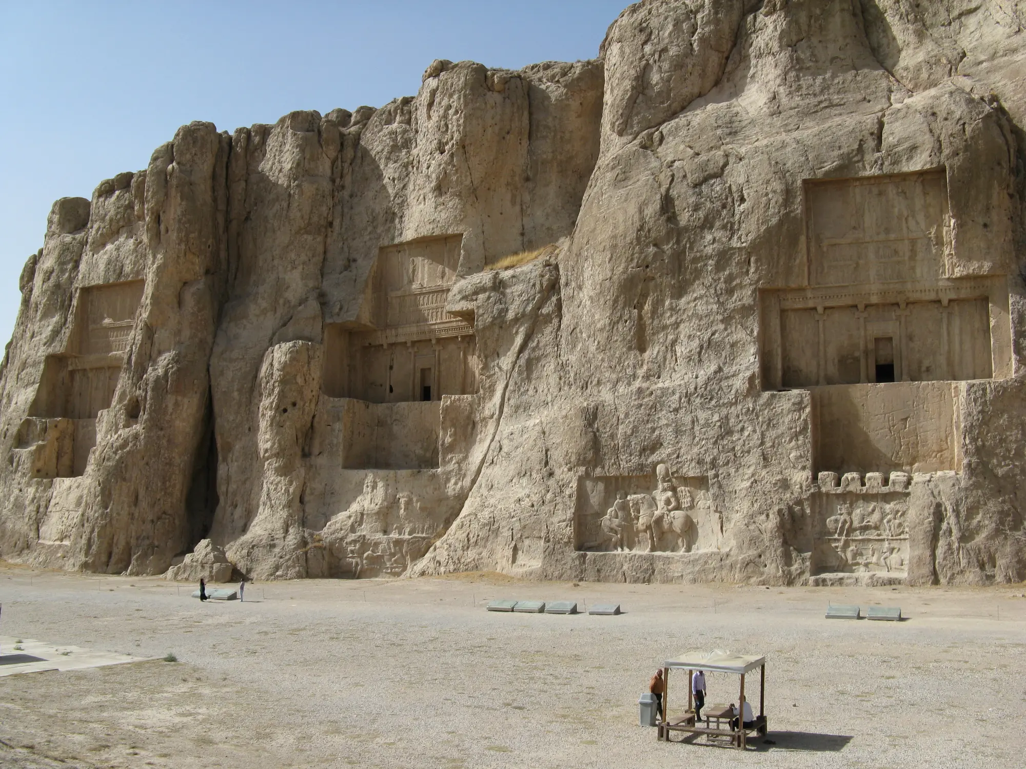 Cross-shaped royal tombs cut high into the cliff face at Naqsh-e Rostam